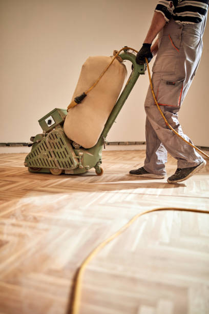 istock Repairman restoring parquet with a sanding machine. 1319617512