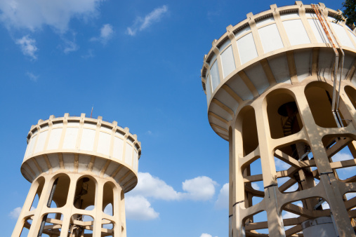 Two Old Water Tanks with Blue Sky Background
