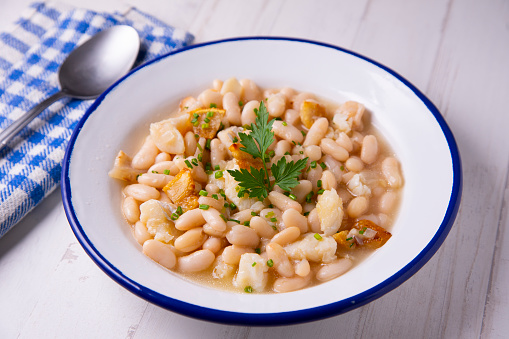 Beans with cod and pork belly. Traditional Spanish recipe.
