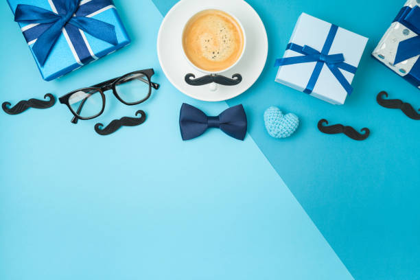 istock Happy Fathers day concept with coffee cup,  tie bow and gift box on blue background 1319618684