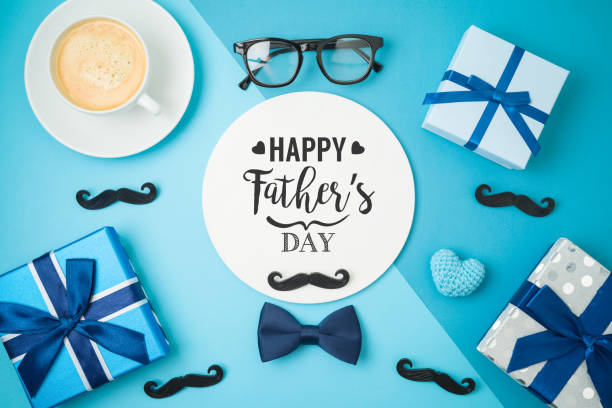 istock Happy Fathers day concept with coffee cup,  tie bow and gift box on blue background 1319618704