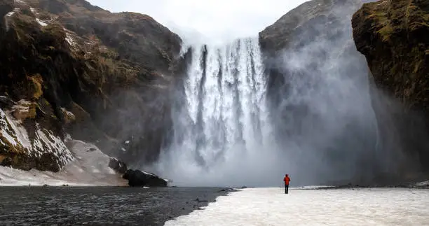 Photo of Skogafoss waterfall with solitary person