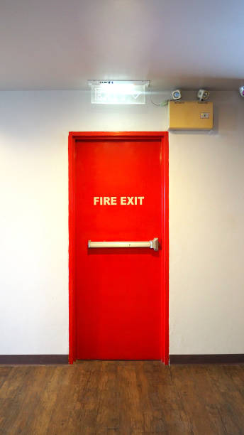istock Emergency fire exit door and red color and white wall in building. 1319621777