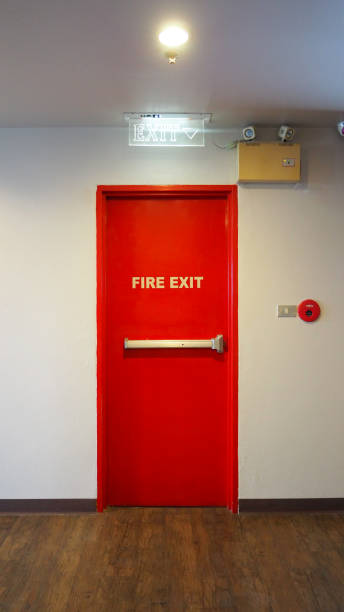 istock Emergency fire exit door and red color and white wall in building. 1319621780