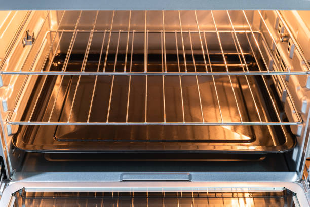 istock Empty open electric oven with a glowing element and metal rack 1319624179