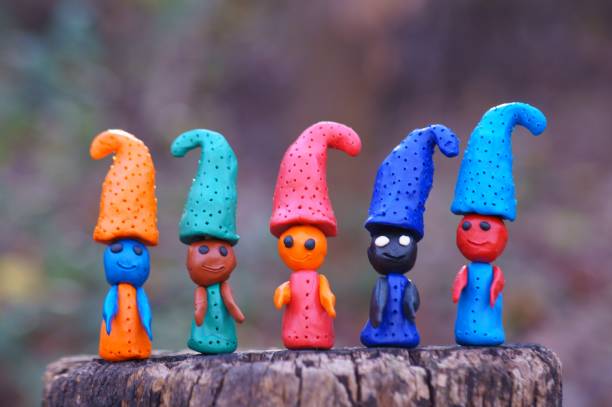 istock Figures of multi-colored gnomes on a colored background. 1319624258