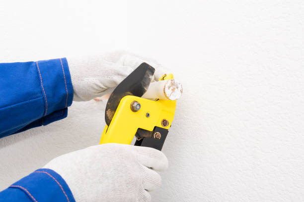istock worker cuts off XLPE pipe for plumbing, close-up 1319626125