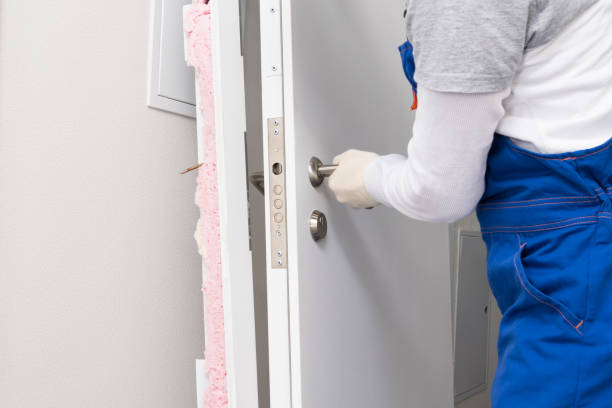 istock a worker is replacing the front door, close-up 1319626211