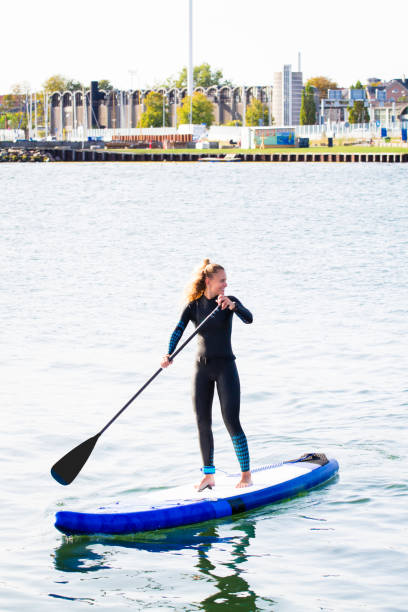 istock Female SUP paddle-boarding in ocean 1319626219