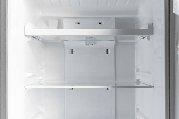 istock inside of clean and empty refrigerator with shelves. Close up. 1319626284
