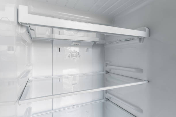 istock inside of clean and empty refrigerator with shelves. Close up. 1319626293