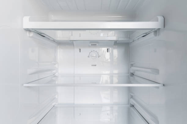 istock inside of clean and empty refrigerator with shelves. Close up. 1319626949