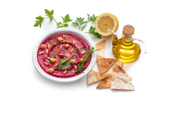 Beet Beetroot hummus bowl closeup with pita flatbread dipping isolated on white background