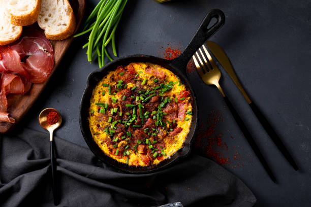 istock Egg omelet with sausage and seasonings in a cast iron pan top view 1319628990