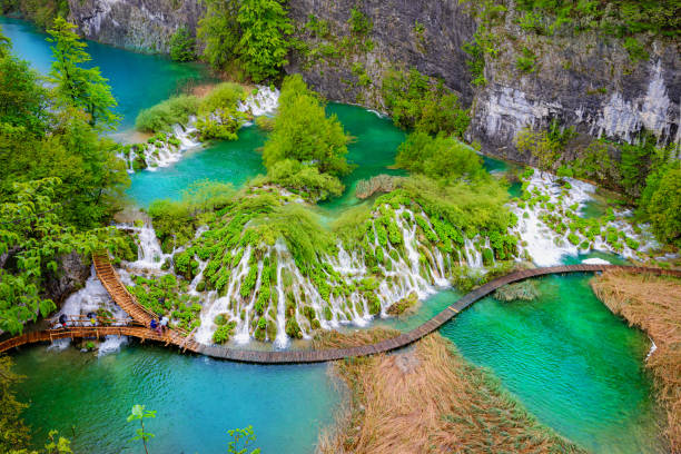 Aerial view of the Plitvice Lakes National Park Aerial top view of a natural park and turquoise lake outdoors in Plitvice, Croatia in the spring season plitvice lakes national park stock pictures, royalty-free photos & images