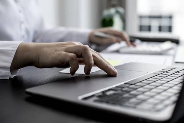 istock A close-up businesswoman using her laptop's touchpad, using her laptop to search the Internet and chat with friends and business partners using a messaging program. Concept of technology. 1319631359
