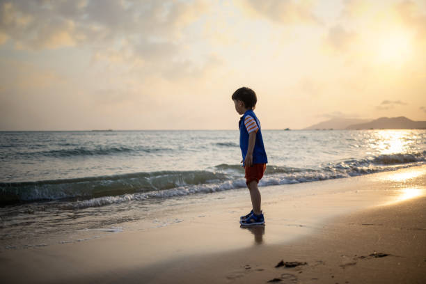 istock Asian  boy playing by the sea 1319631670