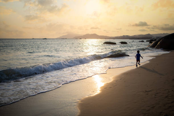 Asian boy playing by the sea