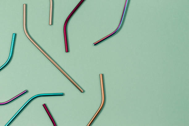 istock Environmental friendly stainless steel reusable drinking straws on pastel background. Top view 1319634202