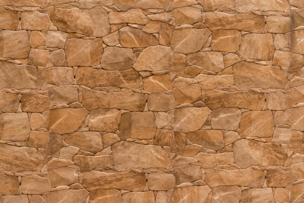 istock Brown stone texture of a wall. Brown stone background 1319634967