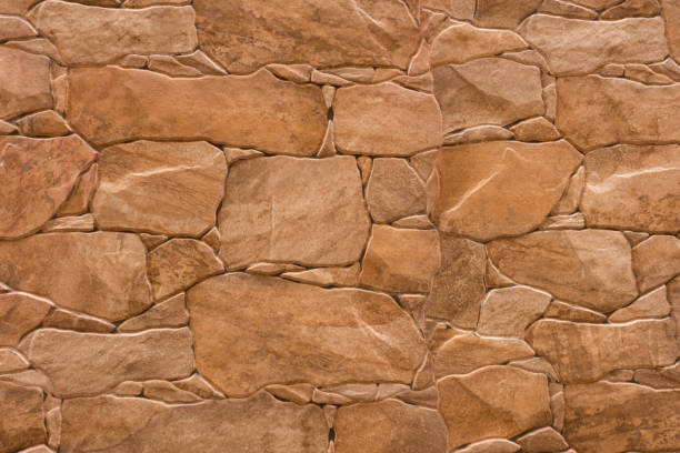 istock Brown stone texture of a wall. Brown stone background 1319634973
