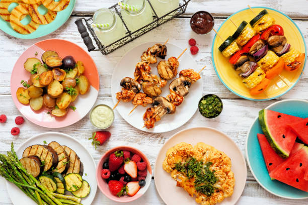 istock Vegan summer bbq or picnic table scene on a white wood background 1319635057