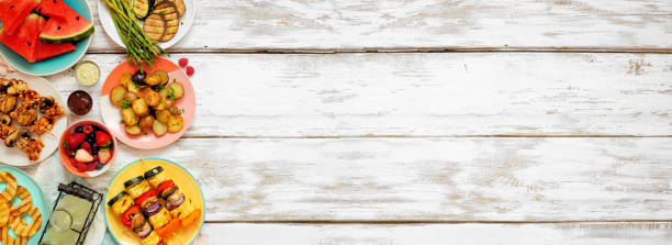 istock Healthy plant based summer bbq side border on a white wood banner background 1319635151