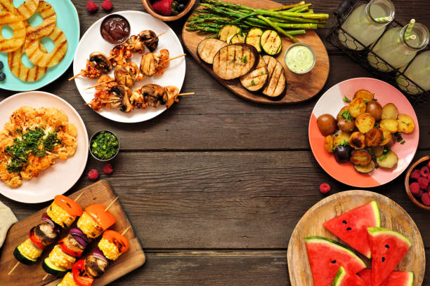 istock Healthy plant based summer bbq arch frame on a dark wood background 1319635521