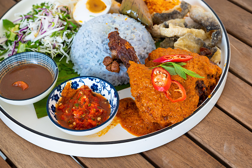 Nasi Kerabu is a type of Nasi Ulam and it’s a popular Malay rice dish especially at Kelatan State and Terengganu State of Malaysia. The blue color of rice is resulting from cooking the petals of Clitoria Ternatea flowers that commonly used as a natural food coloring in cooking it.