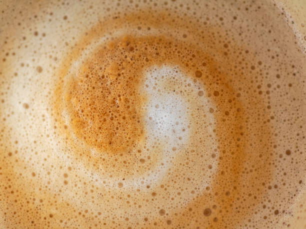Cappuccino milk foam spiral closeup Cappuccino milk foam spiral closeup cappuccino coffee froth milk stock pictures, royalty-free photos & images