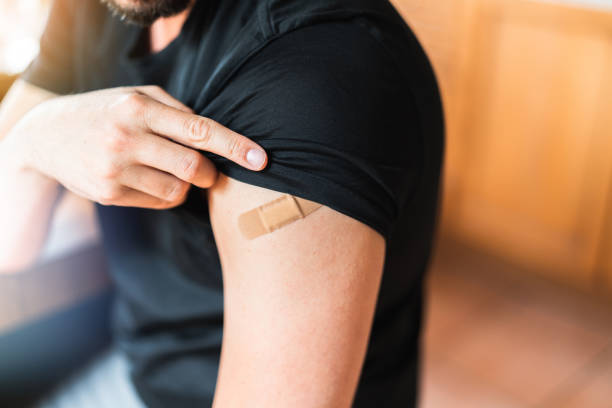 Man with bandage from vaccine shot