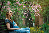 Pregnant woman in blooming park