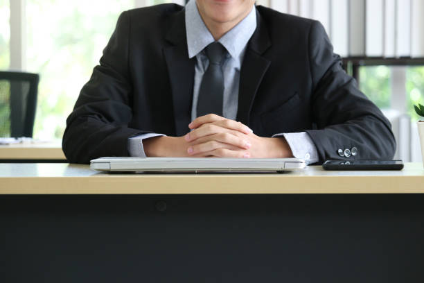istock Businessman sitting at office working desk, his hands are on laptop computer. 1319637718