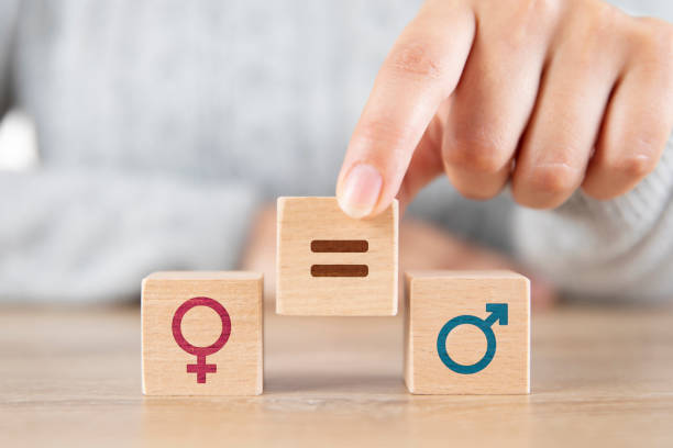 Gender Equality Female hand putting equal symbol between men and woman icons rough hands man stock pictures, royalty-free photos & images