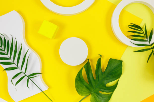 istock Abstract trendy bright yellow background with geometrical forms and podiums for product presentation. Palm tree leaves and podiums to show products. Summer concept. Flat lay, top view, mock up 1319640295