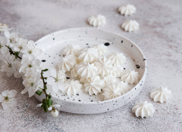 istock Small white meringues in the  ceramic bowl 1319640410