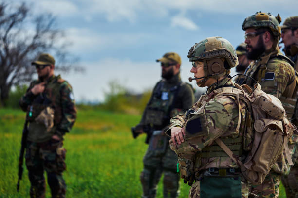 istock Group of airsoft players in uniform with weapons 1319642246