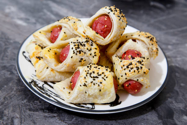 istock Sausage rolls on the wooden tray 1319643370
