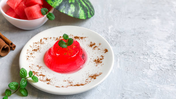 istock Gelo di melone, pudding, jelly with mint and cinnamon on a white plate on a light background. Homemade watermelon dessert. 1319644647