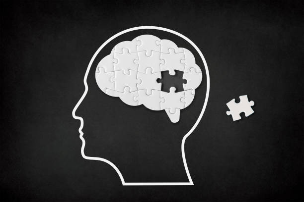 istock Brain shaped white jigsaw puzzle on black background, a missing piece of the brain puzzle, mental health and problems with memory 1319649770