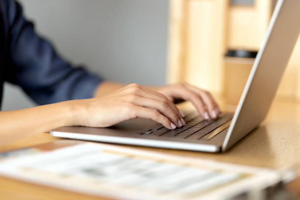 istock Woman hands typing on laptop at cafe 1319654634