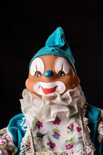 Portrait of a toy clown, avatar on a black background