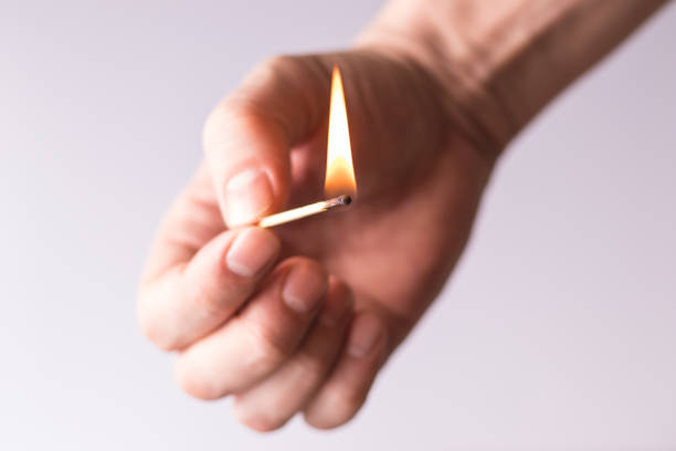 istock Burning match in the hand, flame of fire. 1319656135