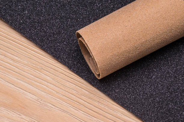 istock Roll and a sheet of sandpaper on a wooden surface 1319656589