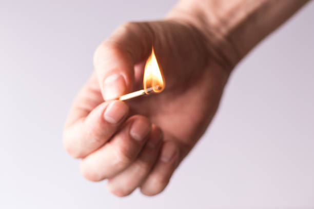 istock Burning match in the hand, flame of fire. 1319657600