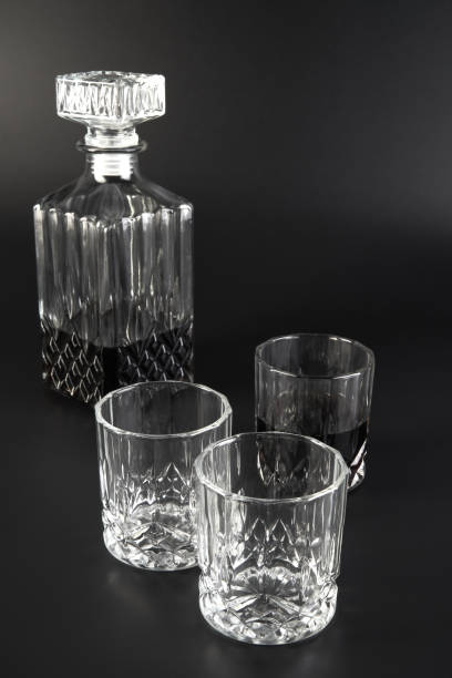 istock Decanter and whiskey glasses on a dark background 1319658017
