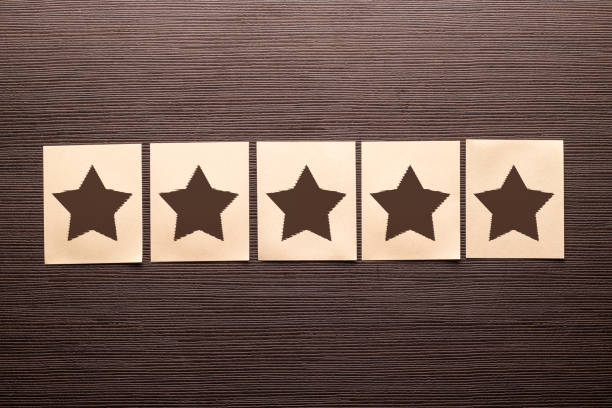 istock Five sheets of paper with stars on a wooden table 1319658020