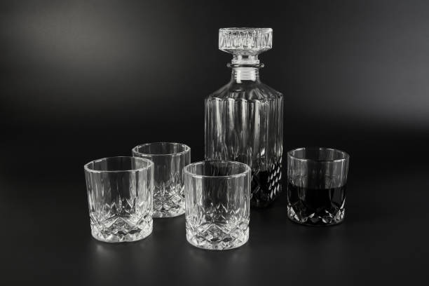 istock Decanter and whiskey glasses on a dark background 1319658040