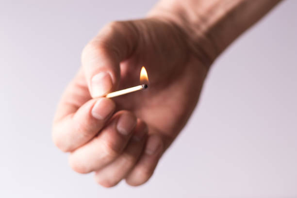 istock Burning match in the hand, flame of fire. 1319659001