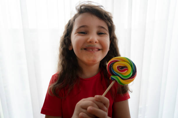 istock Little girl with candy 1319659133